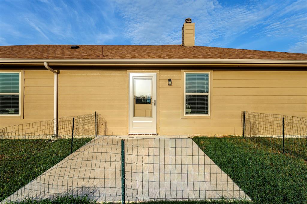 129 Springwood Ranch Loop Springtown, TX 76082 - Photo 23 of 29 Light brown siding with a brown shingle roof