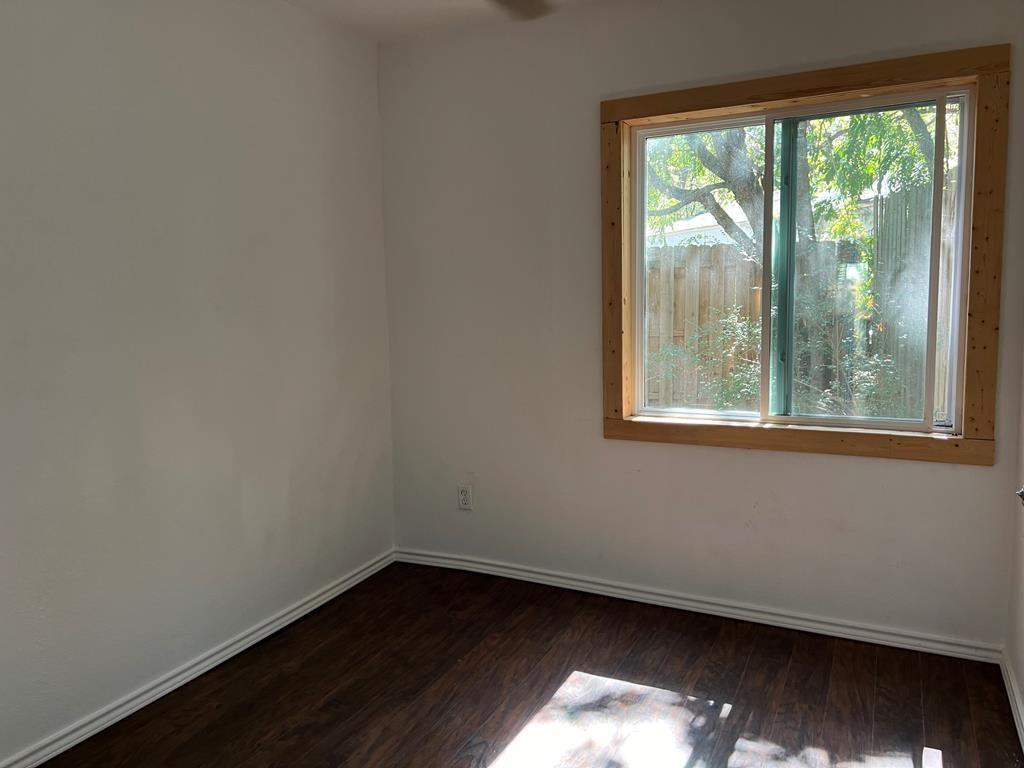 124 Griffith Bend Road Mabank, TX 75156 - Photo 11 of 15 a view of an empty room with wooden floor and a window