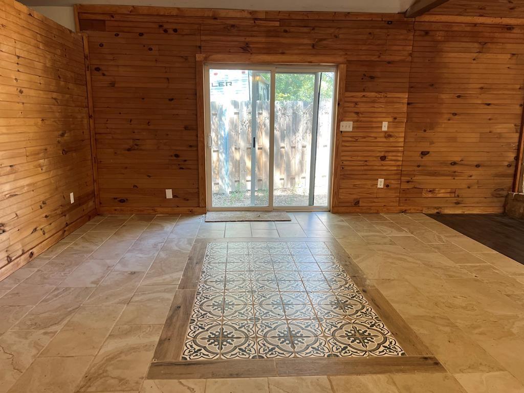 124 Griffith Bend Road Mabank, TX 75156 - Photo 4 of 15 a view of an empty room with a door and a rug
