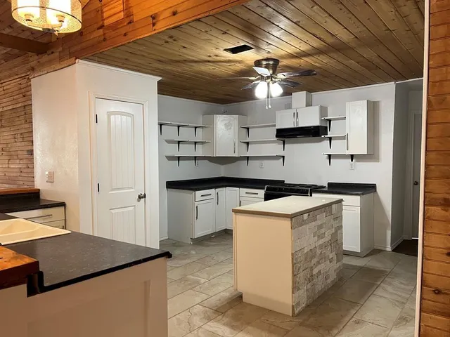 a kitchen with cabinets and stainless steel appliances