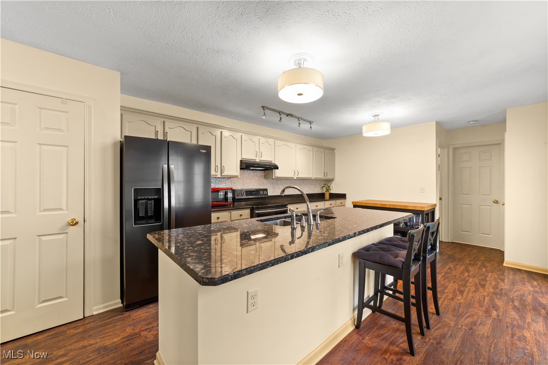 4422 Brooks Road Cleveland, OH 44105 - Photo 11 of 46 Kitchen with appliances with stainless steel finishes, a textured ceiling, sink, and dark wood-type flooring