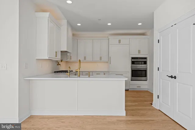 a kitchen with stainless steel appliances granite countertop a refrigerator and a stove top oven