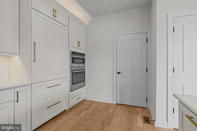 a view of cabinets and wooden floor