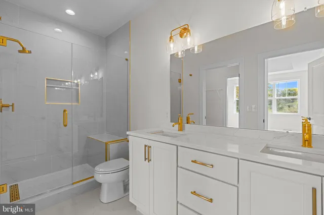 a view of bathroom with a sink a toilet and mirror