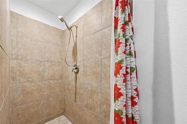 a bathroom with a shower curtain and curtain