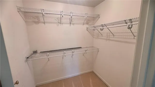a spacious bathroom with a tub sink and mirror