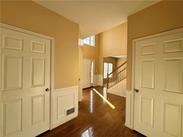 a view of entryway and hall with wooden floor