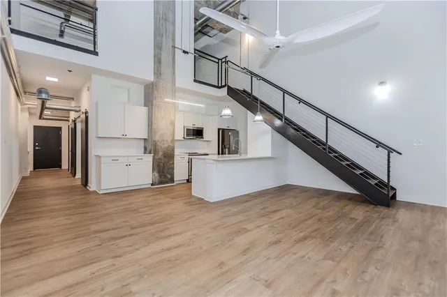 a view of a kitchen with wooden floor and electronic appliances