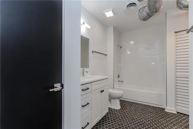 a bathroom with a double vanity sink toilet and shower
