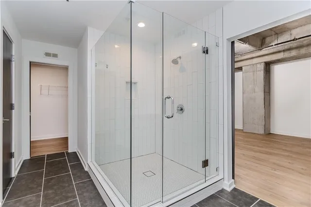 a bathroom with a glass shower door