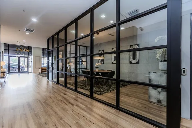 a view of a hallway with wooden floor
