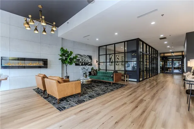 a living room with furniture and a chandelier