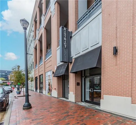 a view of a brick building with many windows