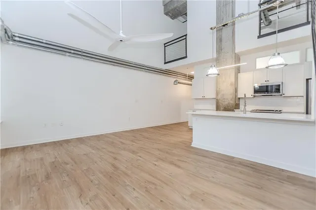 a view of a kitchen with kitchen appliances and cabinets