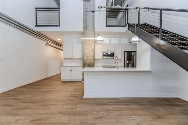 a kitchen with kitchen island wooden cabinets and a stove top oven