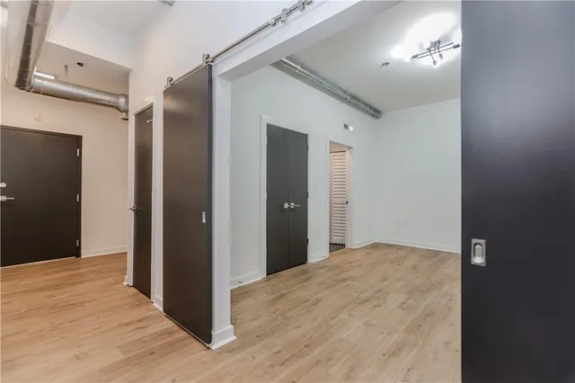 a view of a hallway with wooden floor