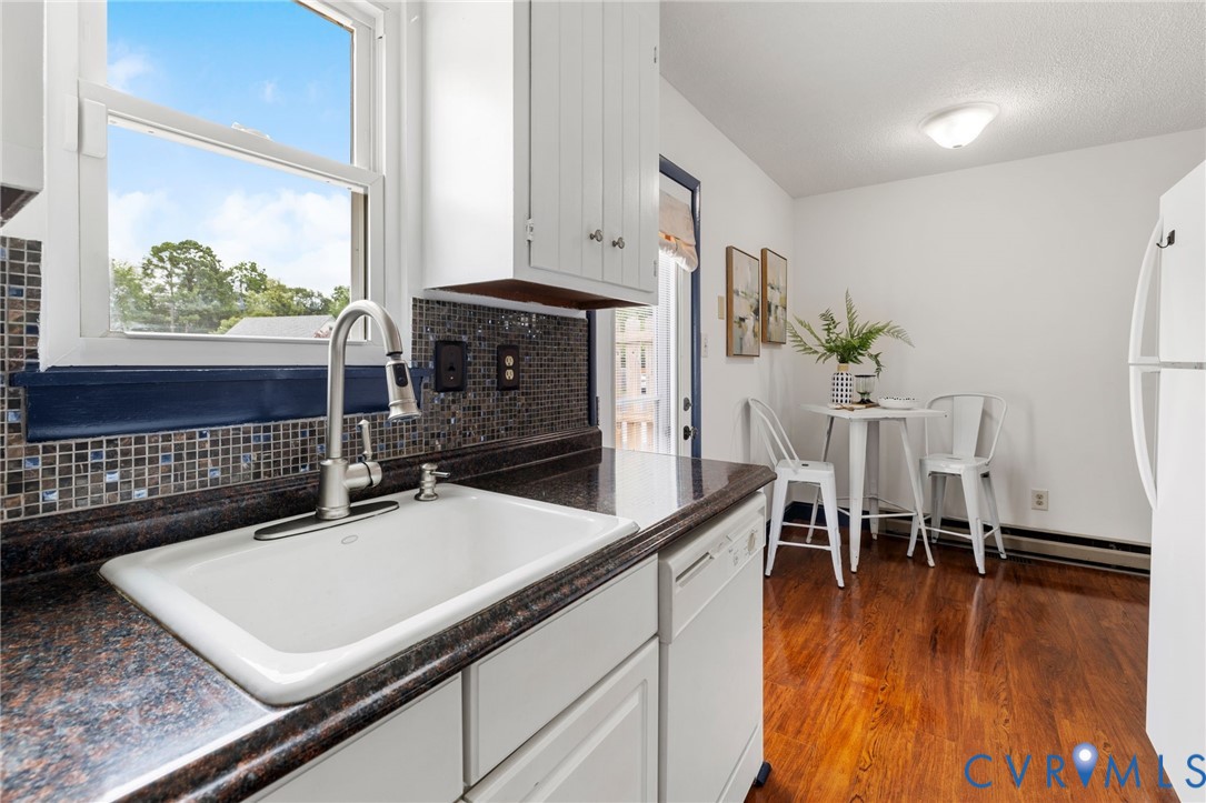 15908 Tri Gate Road Chester, VA 23831 - Photo 12 of 28 a room with wooden floor a rug and a window