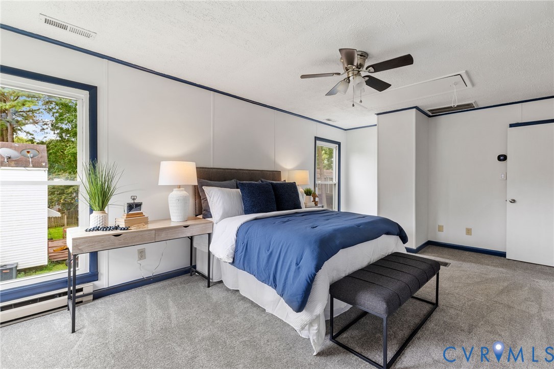 15908 Tri Gate Road Chester, VA 23831 - Photo 14 of 28 a bedroom with a bed and a chandelier