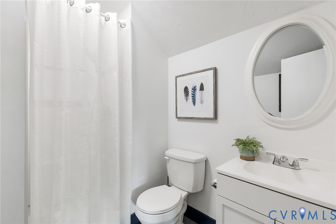 15908 Tri Gate Road Chester, VA 23831 - Photo 16 of 28 a white toilet sitting next to a bathroom sink
