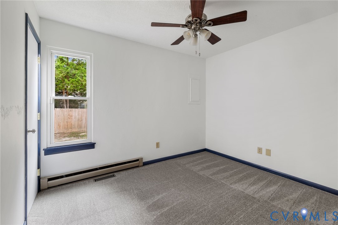 15908 Tri Gate Road Chester, VA 23831 - Photo 17 of 28 an empty room with a window and a fan