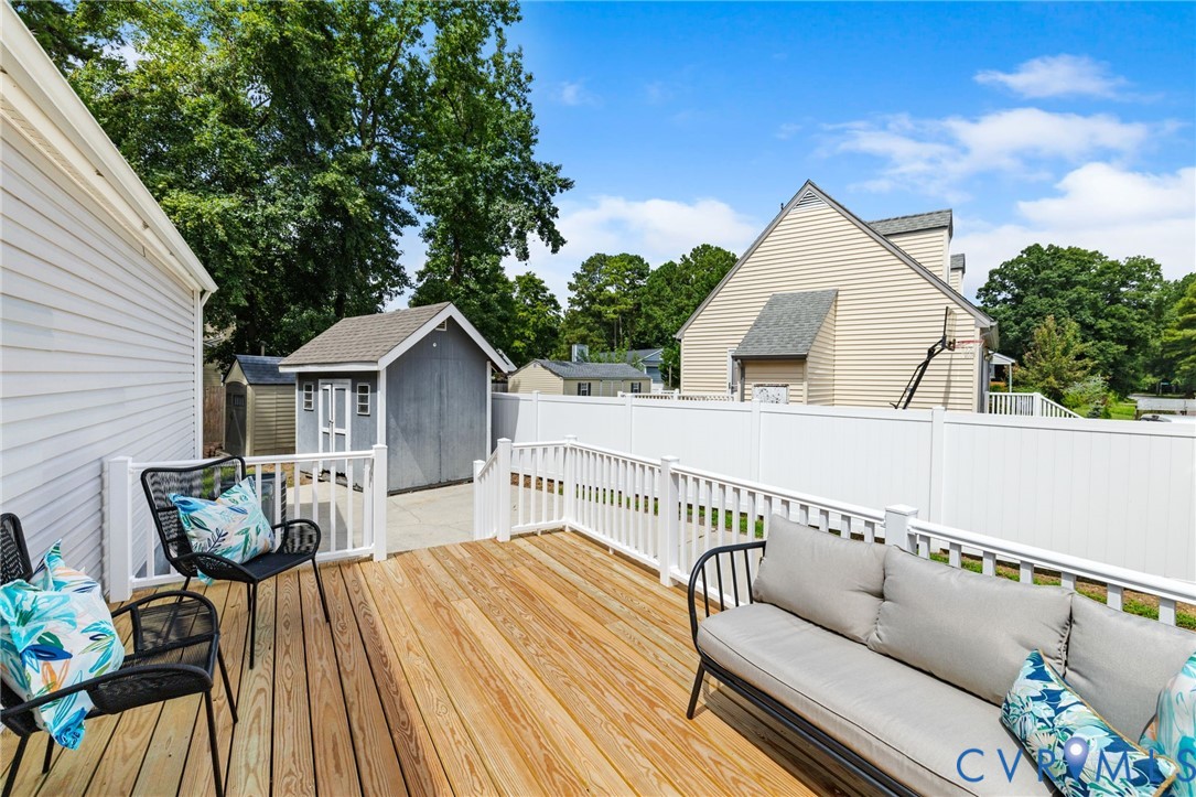 15908 Tri Gate Road Chester, VA 23831 - Photo 21 of 28 a view of a house with wooden deck and furniture