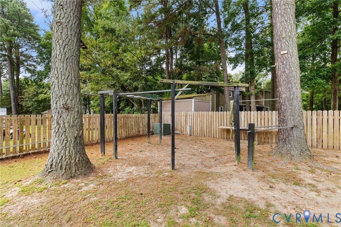 15908 Tri Gate Road Chester, VA 23831 - Photo 26 of 28 a house with a tree in the background