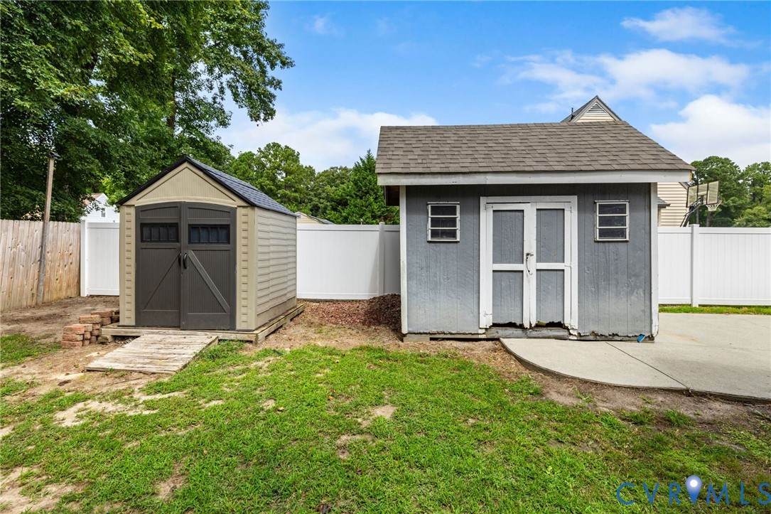 15908 Tri Gate Road Chester, VA 23831 - Photo 27 of 28 a front view of a house with a yard and garage