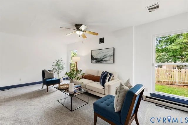 a living room with furniture a wooden floor and a window