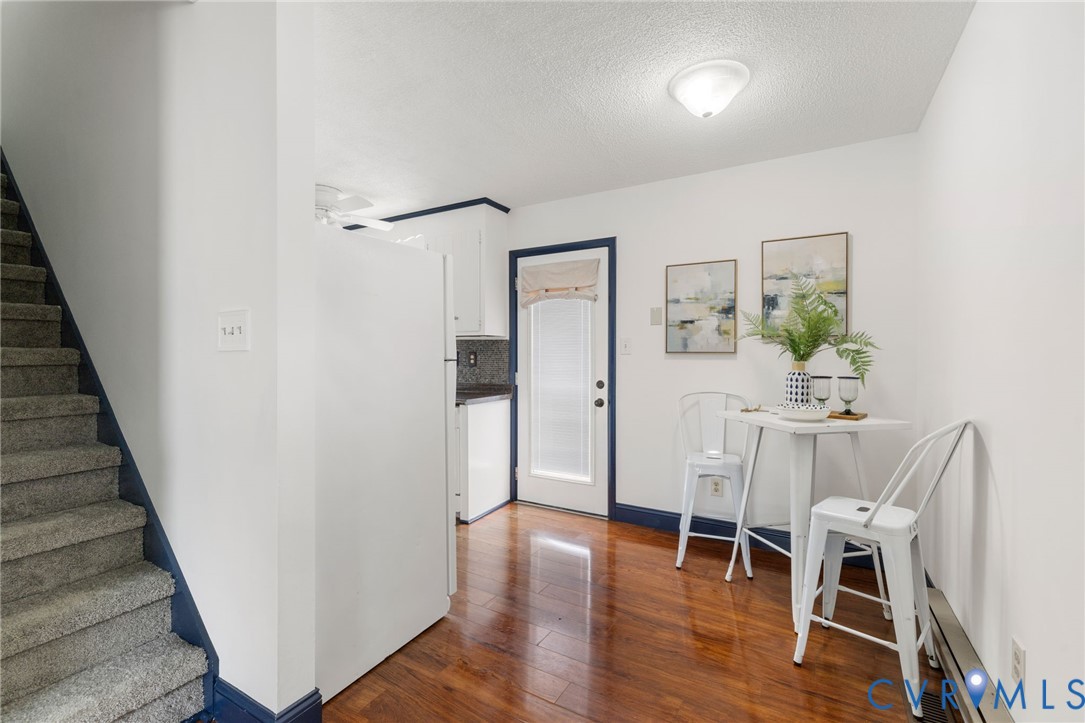 15908 Tri Gate Road Chester, VA 23831 - Photo 7 of 28 a view of a dining room with wooden floor and chairs