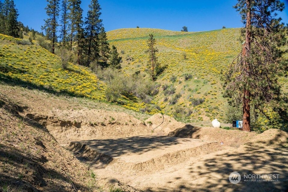 6734 Nahahum Canyon Road Cashmere, WA 98815 - Photo 17 of 32 a view of a yard with snow on the road