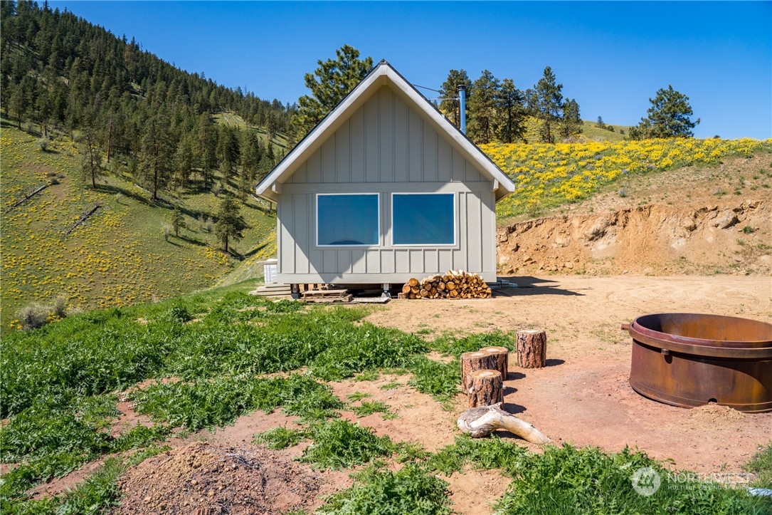 6734 Nahahum Canyon Road Cashmere, WA 98815 - Photo 3 of 32 a front view of a house with garden