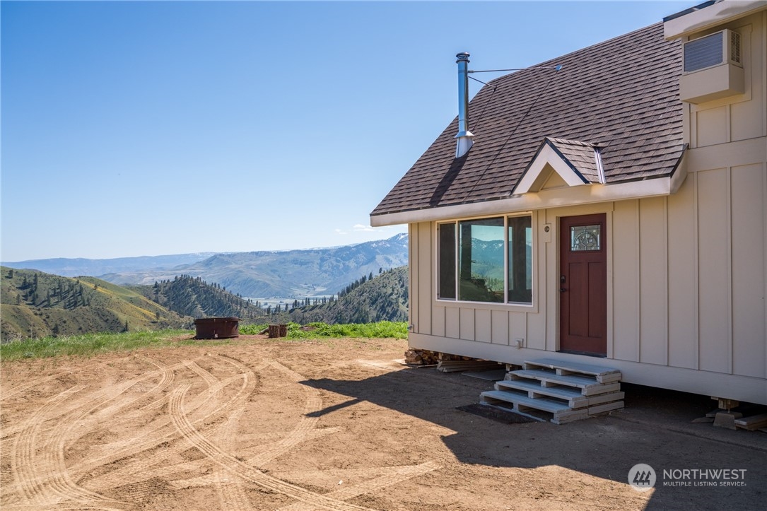 6734 Nahahum Canyon Road Cashmere, WA 98815 - Photo 4 of 32 a front view of a house with a yard