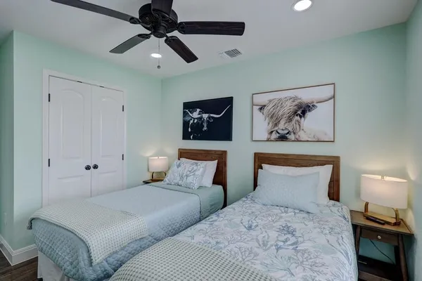 a bedroom with bed and painting on the wall