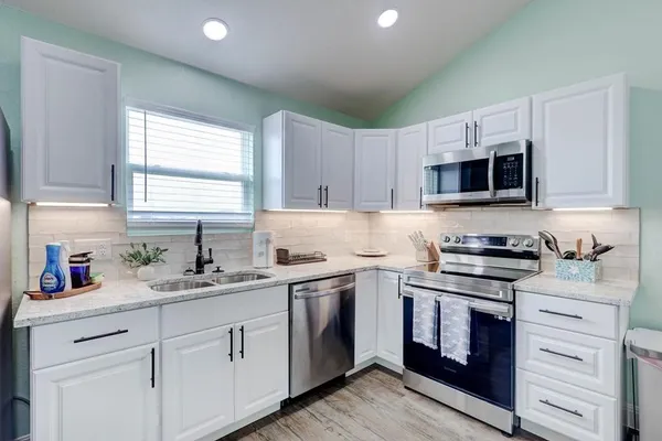 a kitchen with appliances cabinets and a sink