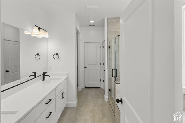 205 East 690th Street North Logan, UT 84321 - Photo 44 of 52 Dual vanity with white cabinetry and black hardware