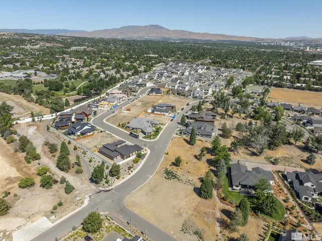 an aerial view of a city with mountains