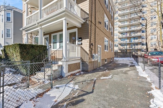 a view of a building with a bench in front of building