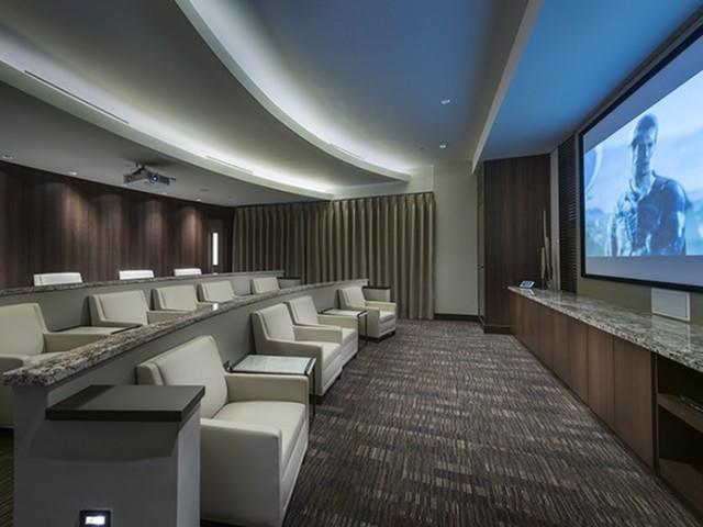 3150 Roswell Road Northwest, Unit 1410 Atlanta, GA 30305 - Photo 7 of 25 a lobby with furniture and a flat screen tv