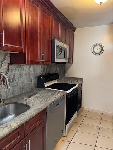 a kitchen with a sink stove and cabinets