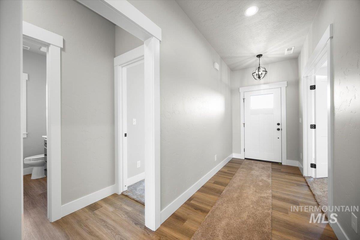 103 Ash Street Parma, ID 83660 - Photo 10 of 22 Entrance foyer featuring wood finished floors and a textured ceiling