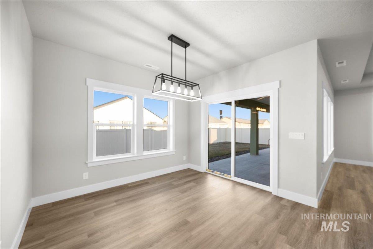 103 Ash Street Parma, ID 83660 - Photo 11 of 22 Unfurnished dining area featuring wood finished floors and plenty of natural light