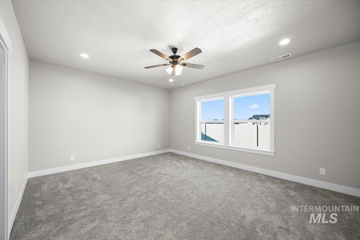 103 Ash Street Parma, ID 83660 - Photo 12 of 22 Carpeted spare room with recessed lighting, a ceiling fan, and a textured ceiling