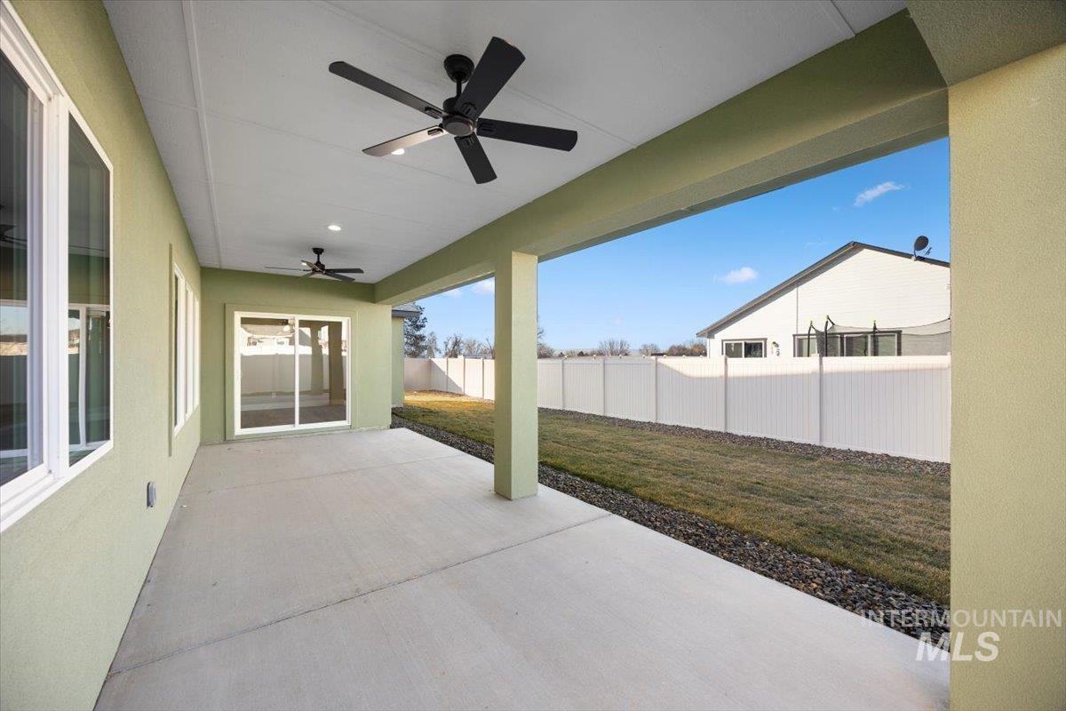 103 Ash Street Parma, ID 83660 - Photo 19 of 22 Fenced backyard with a ceiling fan and a patio area