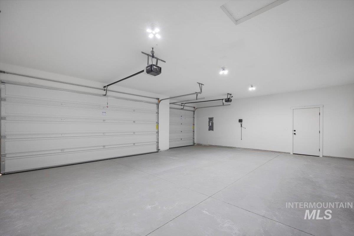 103 Ash Street Parma, ID 83660 - Photo 20 of 22 Garage with electric panel and a garage door opener