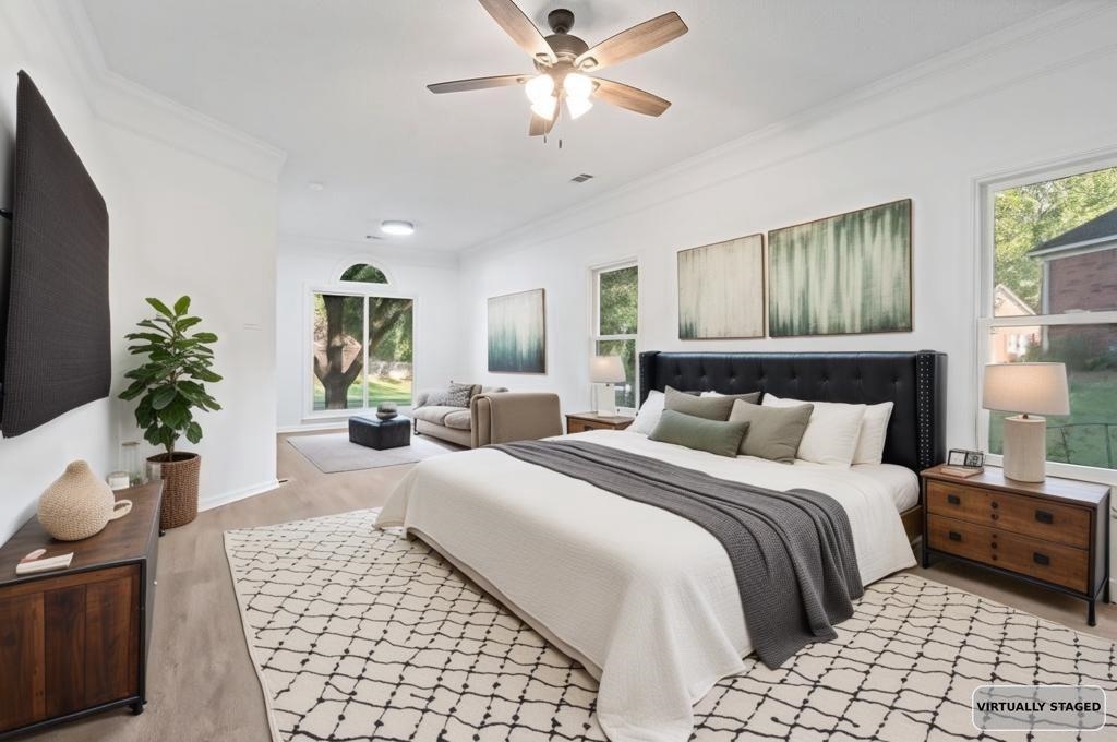 2389 Carrol Ridge Lane Cordova, TN 38016 - Photo 11 of 18 Bedroom featuring a ceiling fan, crown molding, multiple windows, and light wood-style flooring