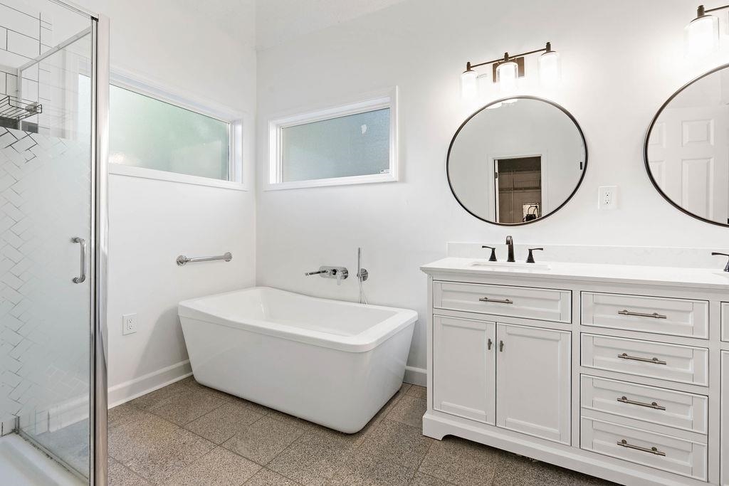 2389 Carrol Ridge Lane Cordova, TN 38016 - Photo 12 of 18 Full bath featuring a shower stall, a freestanding bath, and double vanity