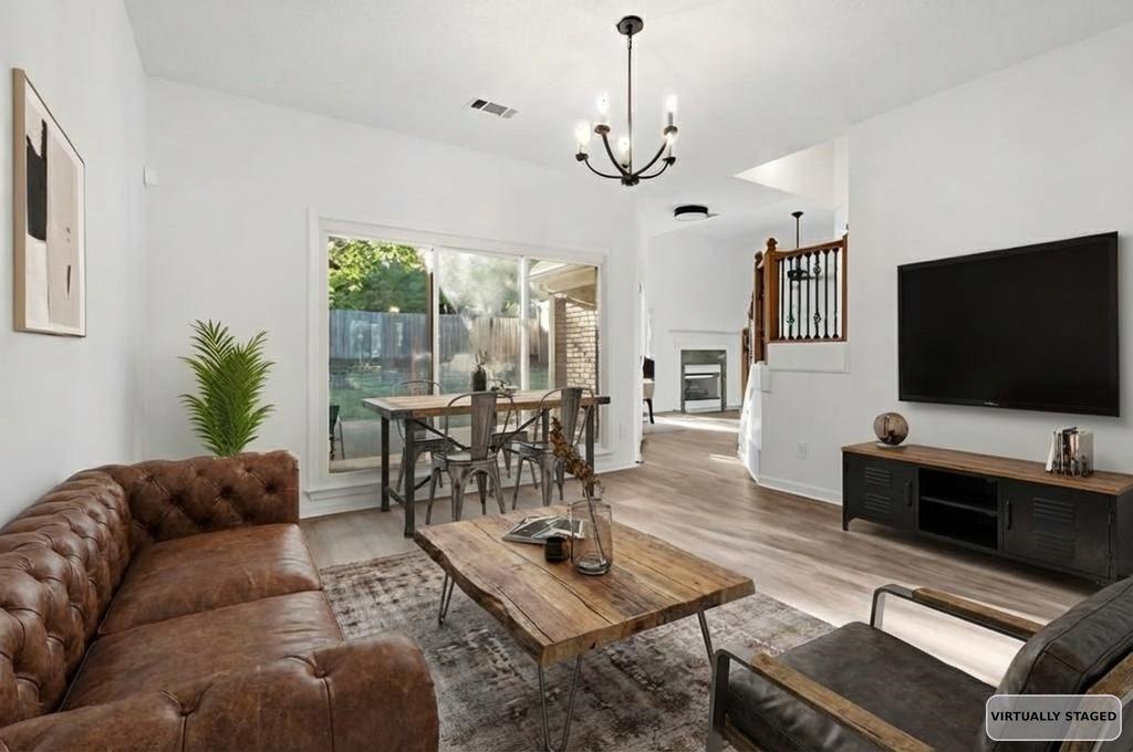 2389 Carrol Ridge Lane Cordova, TN 38016 - Photo 5 of 18 Living area featuring wood finished floors and a chandelier