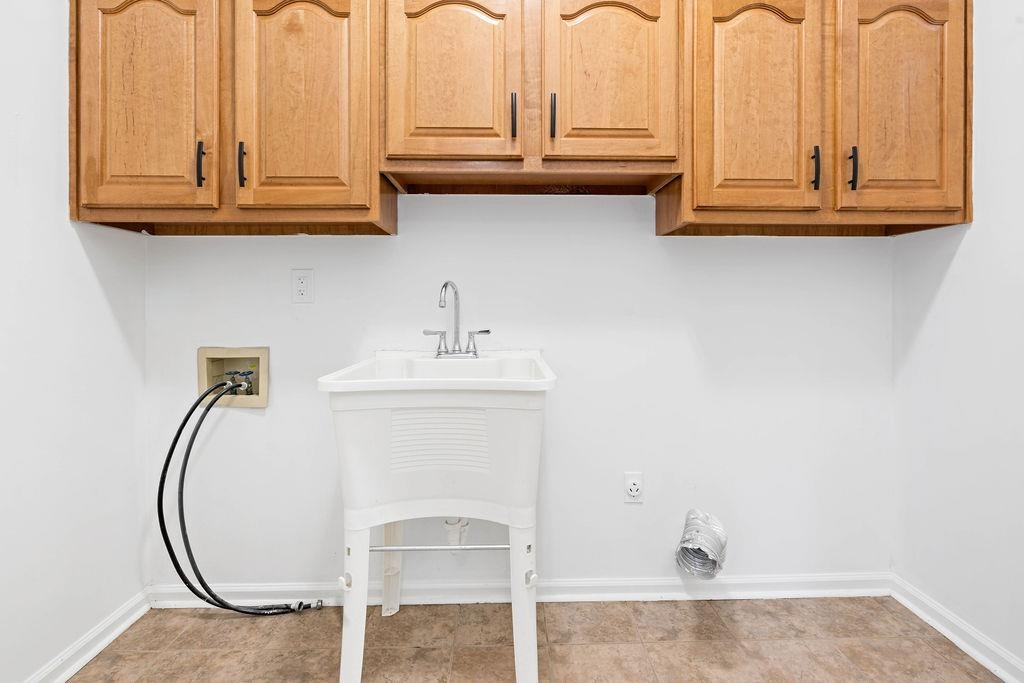 2389 Carrol Ridge Lane Cordova, TN 38016 - Photo 8 of 18 Laundry area featuring washer hookup and cabinet space