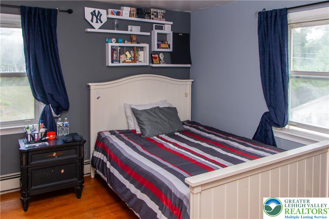 3582 Country Club Road Easton, PA 18045 - Photo 30 of 48 A comforting bedroom with warm wood flooring and ample natural light invites restful slumber.
