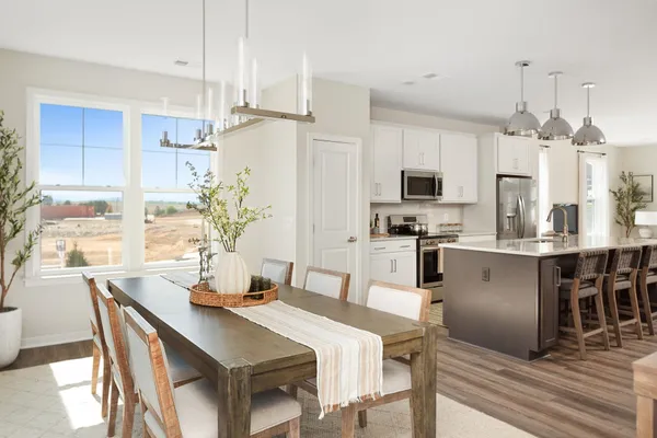 a kitchen with kitchen island a large counter top space appliances and cabinets